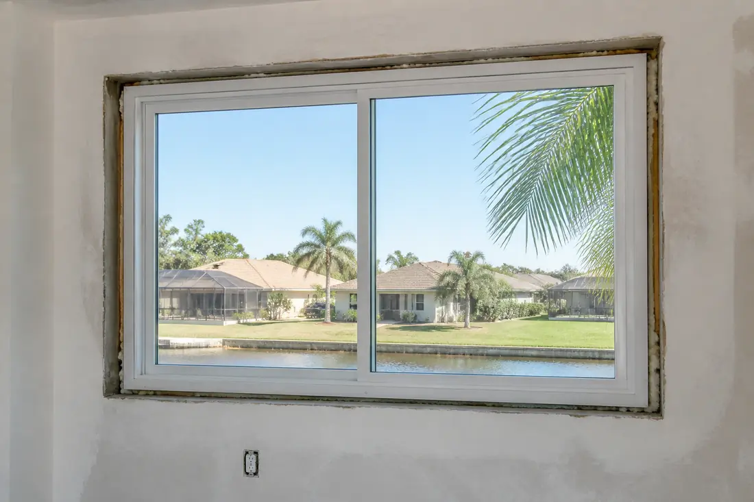 A replacement window frame set inside an existing masonry opening
