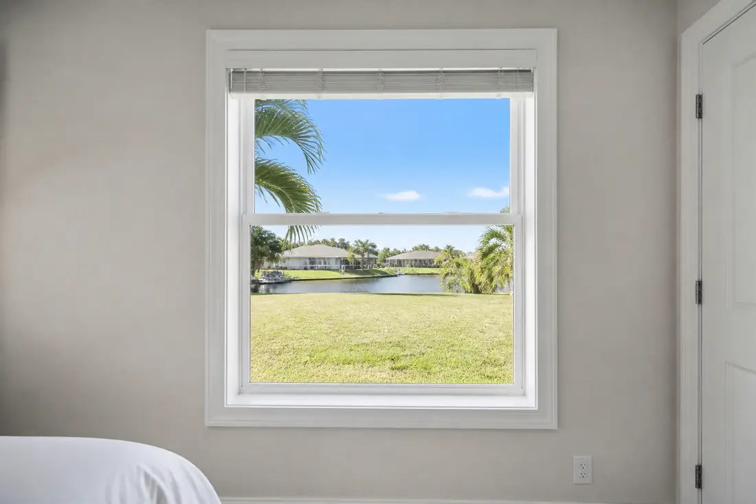 A bedroom window standing fully open, seen from inside the room