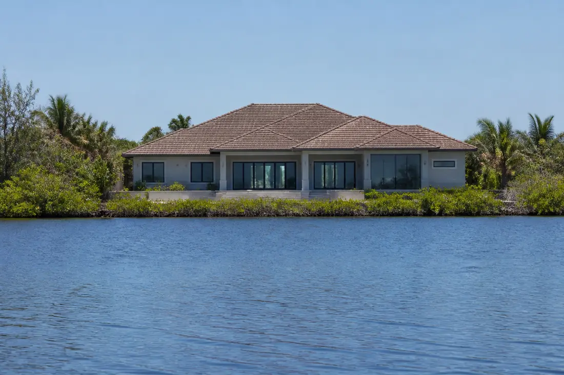 A waterfront house facing open water across a wide basin