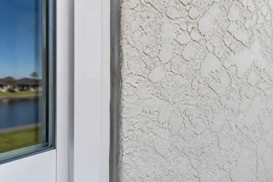The sealant joint between a window frame and the masonry around it