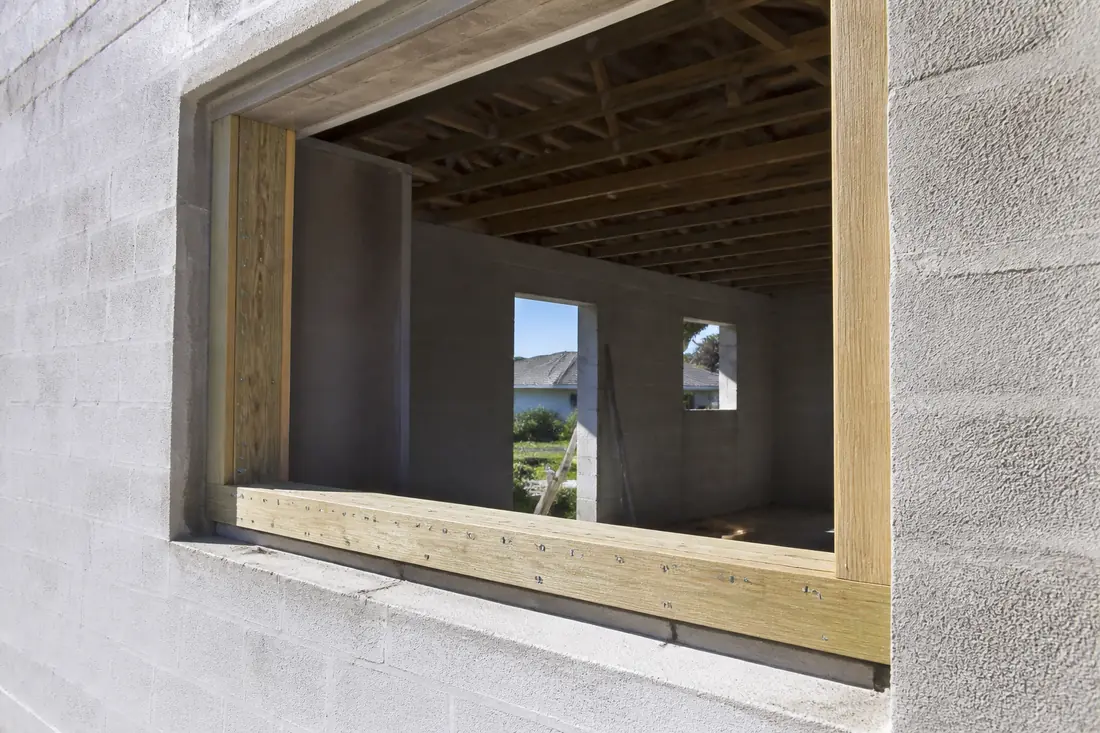 A two-inch pressure-treated buck fastened into a block opening before the window goes in